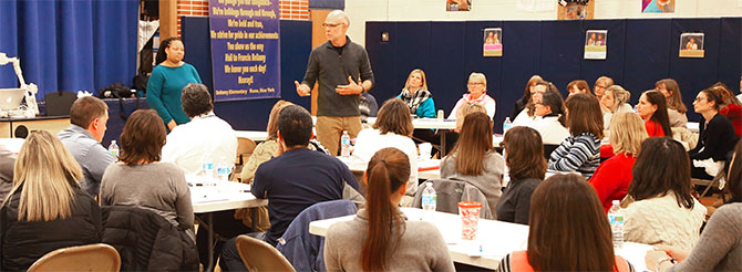 Nick Faber, standing, vice president of the Saint Paul Federation of Teachers, talks to Rome TA members about best practices for parent-teacher home visits based on his union’s own experience. Rome teachers are embarking on their own union-led home visit program this spring.